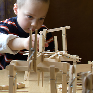 child building with popsicle sticks