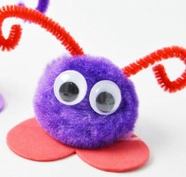 pom pom with googly eyes, red antennae, and foam heart