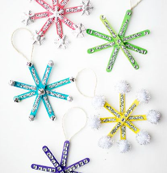 Colored popsicle sticks with sequins and pom poms