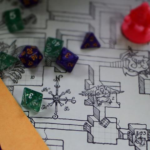 Dungeons and Dragons dice and map