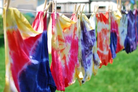 tie dye shirts hanging on a line