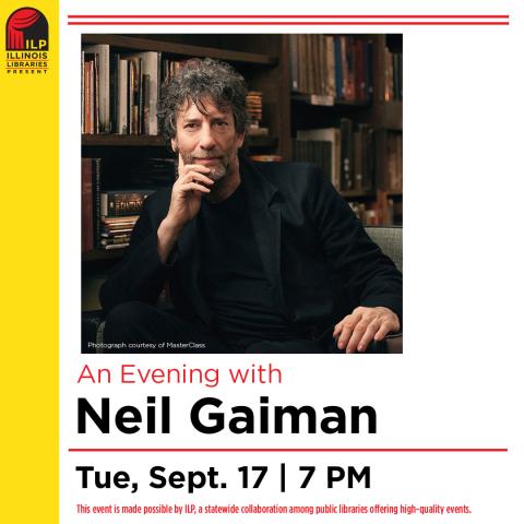 Neil Gaiman, a Caucasian male with brownish gray curly hair, a short beard and a relaxed face is sitting down, resting his chin on his hand. He is wearing a black suit and is sitting in front of antique-looking books and bookshelves. 