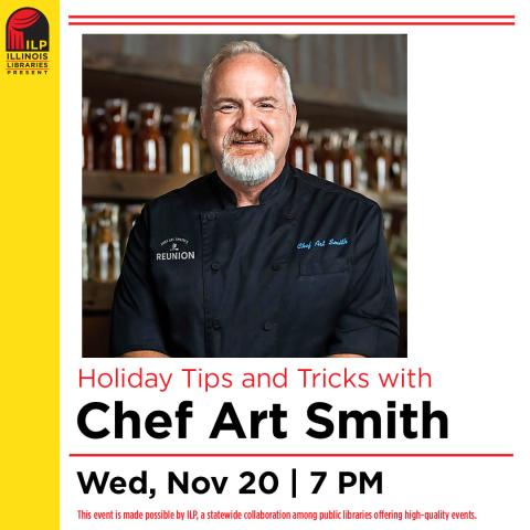 Chef Art Smith, a Caucasian male with white hair and a white beard partly smiling in a black chef coat embroidered with his name on one side and "REUNION" on the other. The photo is set against a blurred background of large assorted spice jars.