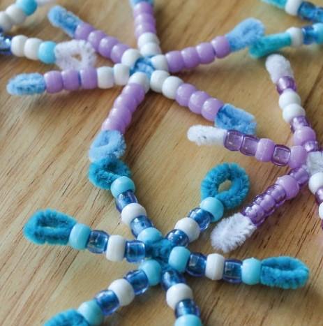 Multicolored pipe cleaners and beads shaped into snowflakes