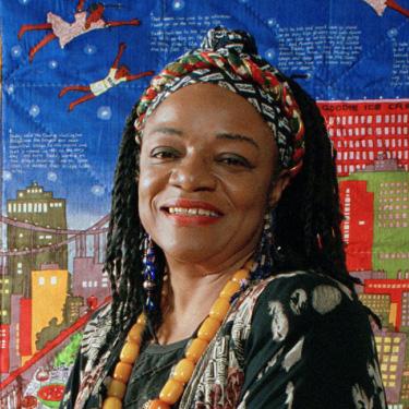 Faith Ringgold in front of quilt