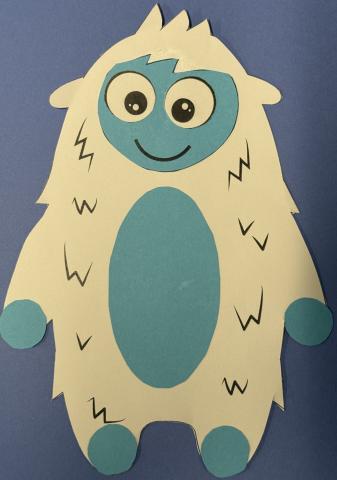 White yeti with blue face feet, hands, and tummy on blue background