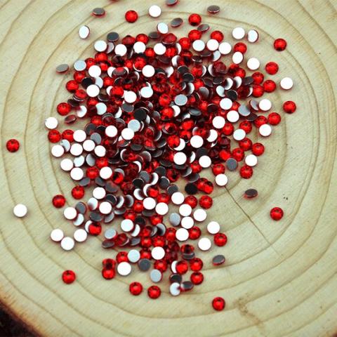 pile of red diamond art crystals on a circular platter