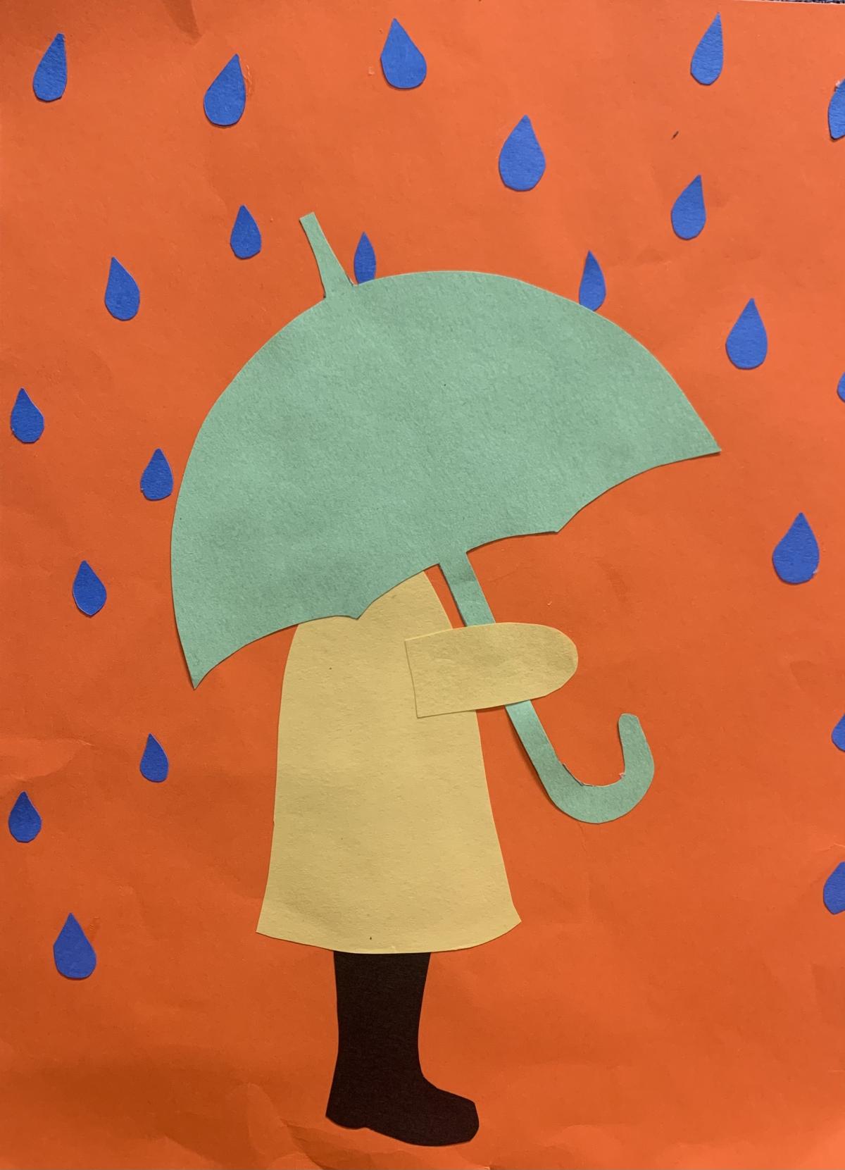 child in yellow jacket with green umbrella against orange paper background