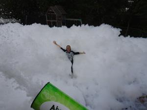 Child playing in foam from cannon